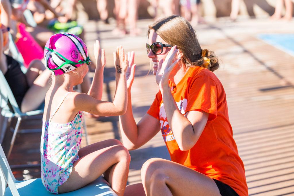 coach encouraging a young swimmer before a race