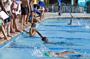 young swimmers finish a summer swim race relay
